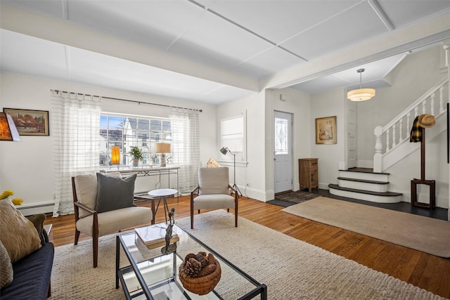 living room featuring stairway, wood finished floors, and a healthy amount of sunlight