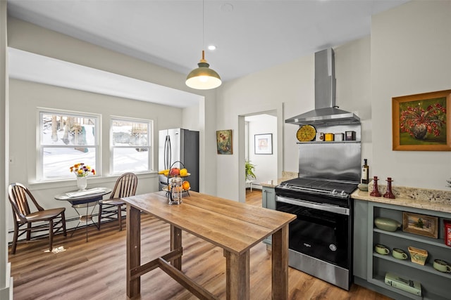 kitchen with open shelves, appliances with stainless steel finishes, a baseboard heating unit, wall chimney range hood, and wood finished floors