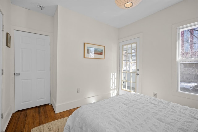 bedroom with baseboards and wood finished floors