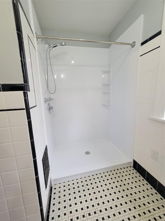 bathroom featuring a stall shower and visible vents