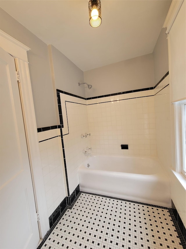 bathroom with shower / tub combination and tile walls