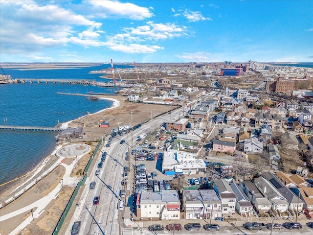 birds eye view of property featuring a water view and a beach view