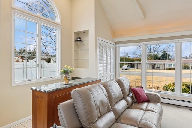 interior space with high vaulted ceiling, baseboard heating, a wealth of natural light, and baseboards