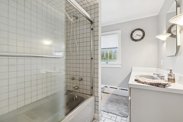 bathroom with toilet, a baseboard heating unit, bath / shower combo with glass door, vanity, and crown molding