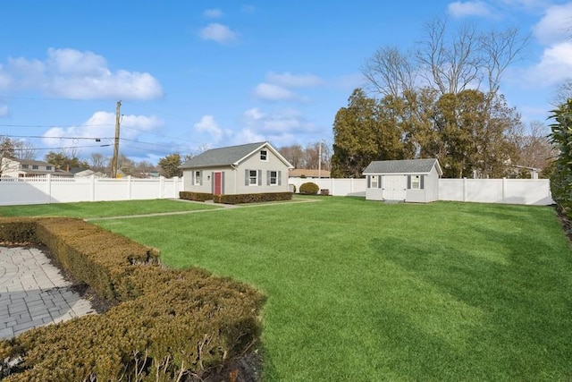 view of yard with a fenced backyard, a storage unit, and an outdoor structure