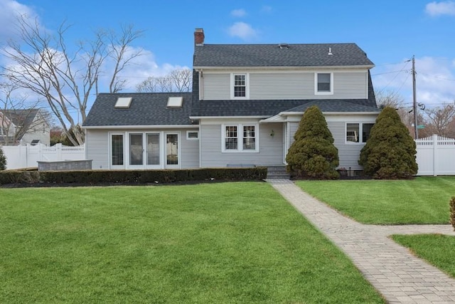 view of front of home with a front lawn, a chimney, a shingled roof, and fence