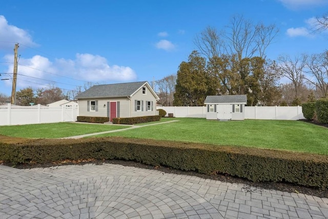 view of yard with an outbuilding and a fenced backyard