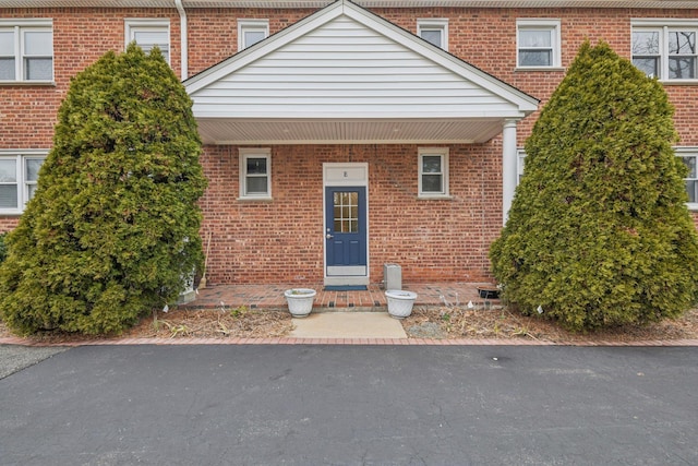 property entrance with brick siding