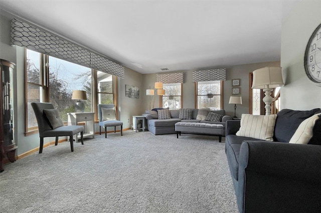 carpeted living area with visible vents and baseboards