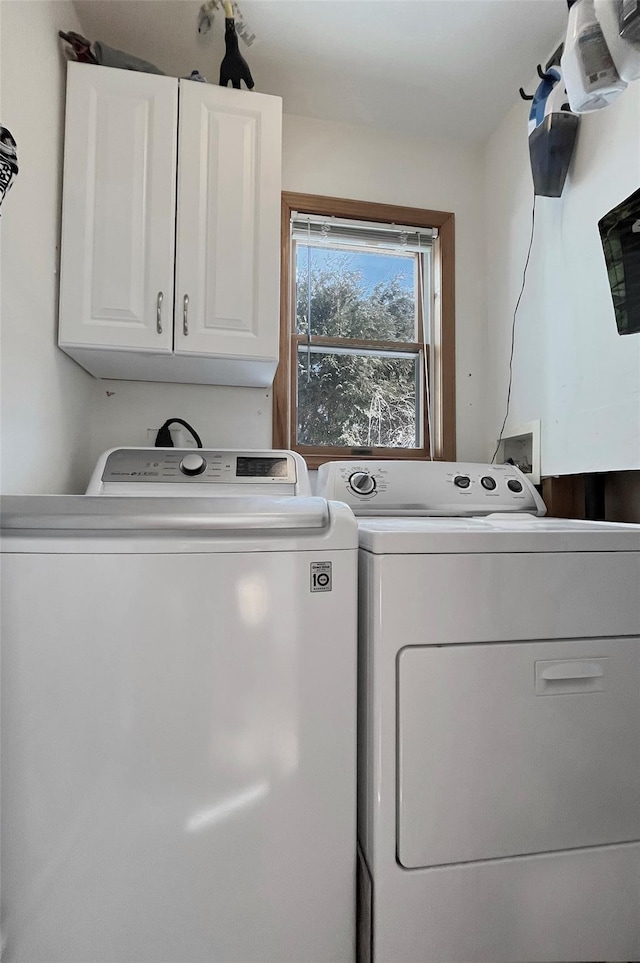 laundry room featuring cabinet space and separate washer and dryer