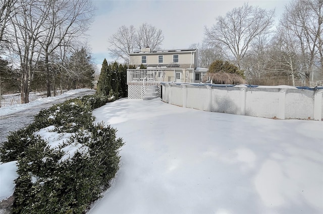 snowy yard featuring a deck