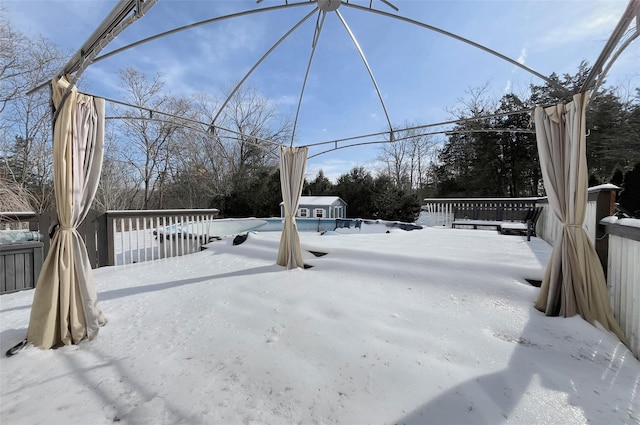 yard covered in snow with a storage shed and an outbuilding