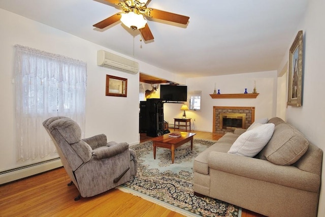 living room with a baseboard radiator, an AC wall unit, wood finished floors, and a fireplace