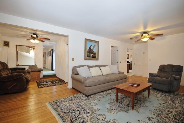 living area featuring ceiling fan and wood finished floors