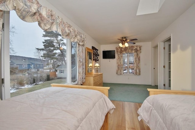 bedroom featuring a ceiling fan and wood finished floors