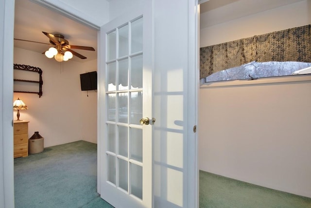 corridor featuring french doors and carpet