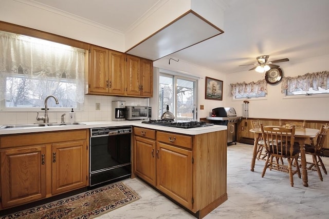 kitchen featuring dishwasher, a peninsula, marble finish floor, gas stovetop, and a sink