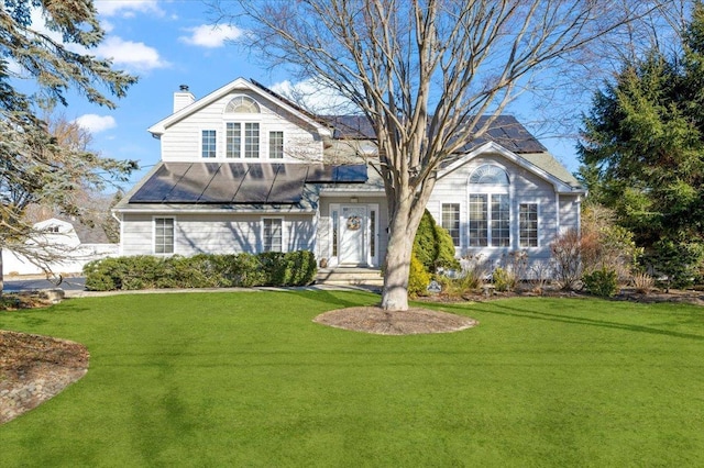 view of front of house featuring a front yard and a chimney