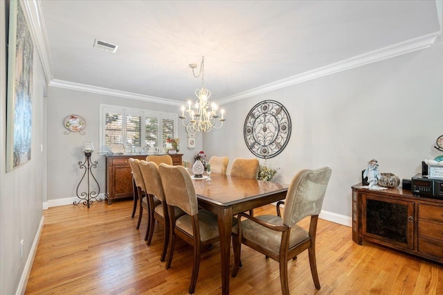 dining space featuring baseboards, light wood finished floors, an inviting chandelier, and crown molding