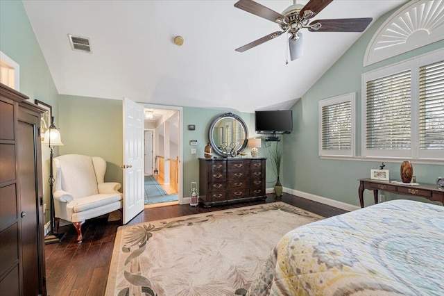 bedroom with lofted ceiling, a ceiling fan, visible vents, baseboards, and dark wood finished floors