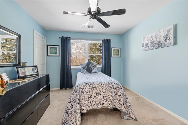 bedroom featuring light carpet, ceiling fan, visible vents, and baseboards