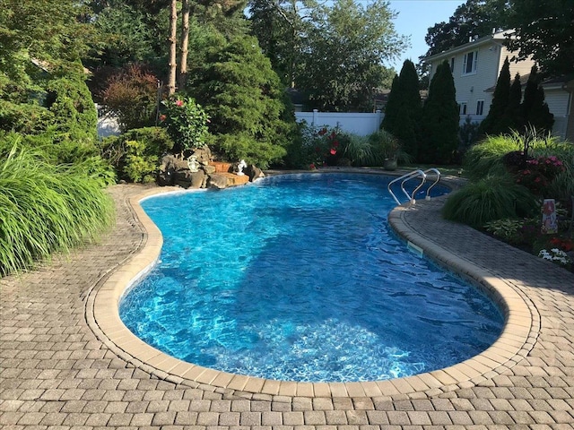 view of swimming pool with fence and a fenced in pool