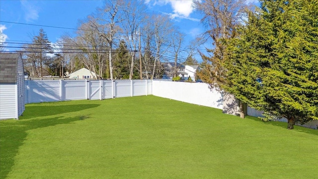 view of yard featuring a fenced backyard and a gate