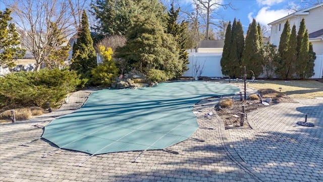 view of swimming pool featuring a patio area, fence, and a fenced in pool