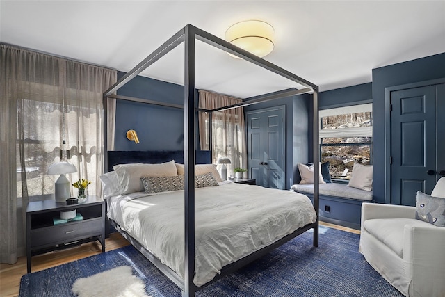 bedroom featuring multiple windows and wood finished floors