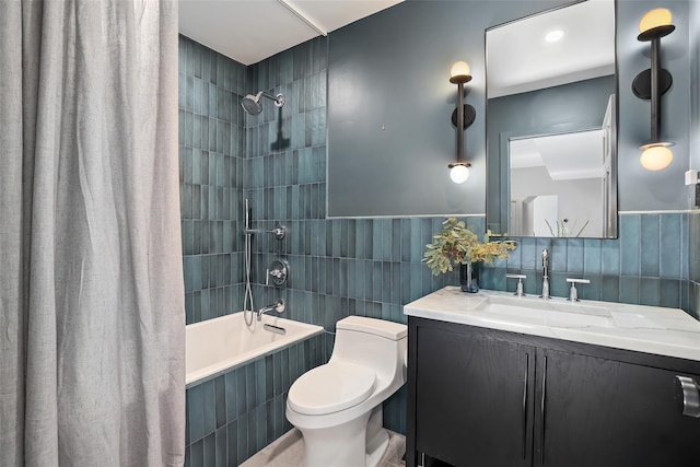 full bathroom with tiled shower / bath, toilet, tile walls, and vanity