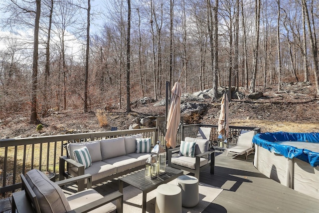 deck featuring an outdoor living space and a view of trees