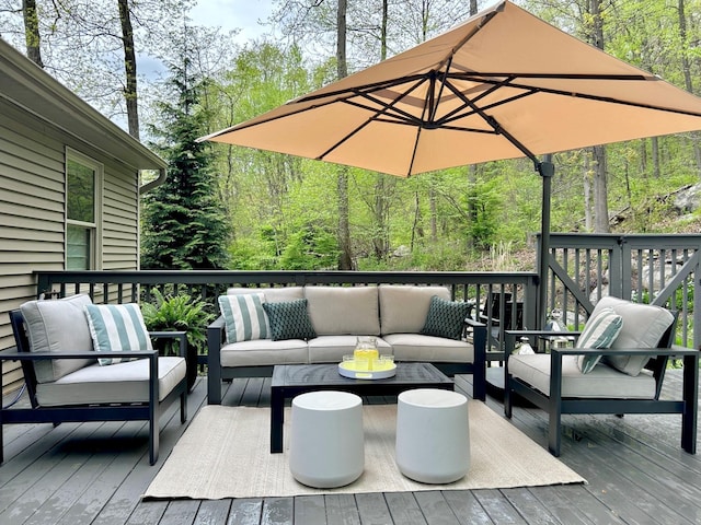 wooden deck featuring a wooded view and an outdoor hangout area