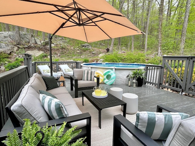 wooden terrace featuring an outdoor pool and an outdoor hangout area