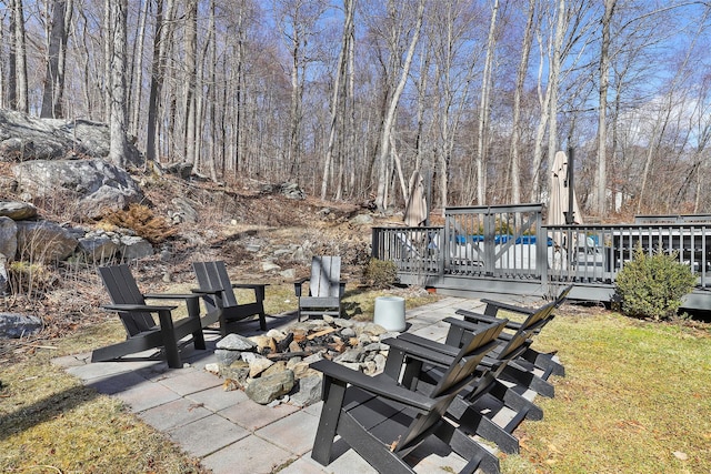 view of patio featuring a wooden deck and a fire pit