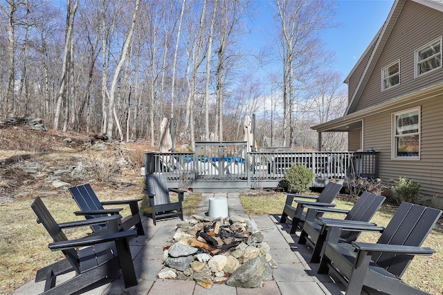 view of patio / terrace featuring a fire pit and a deck