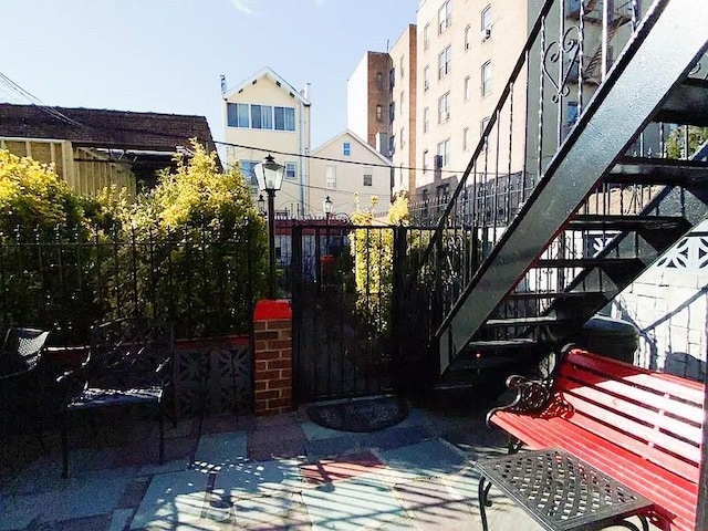 view of patio / terrace with stairs and fence