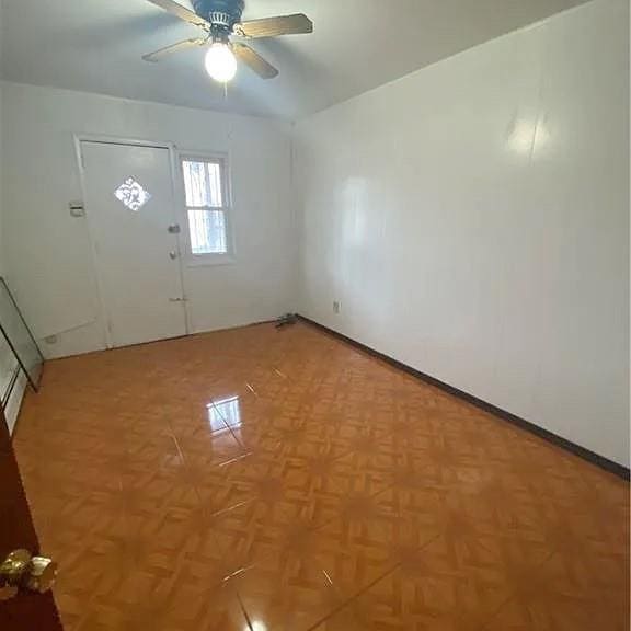 foyer with a ceiling fan