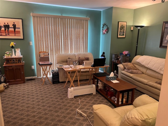 living area with dark colored carpet and baseboards