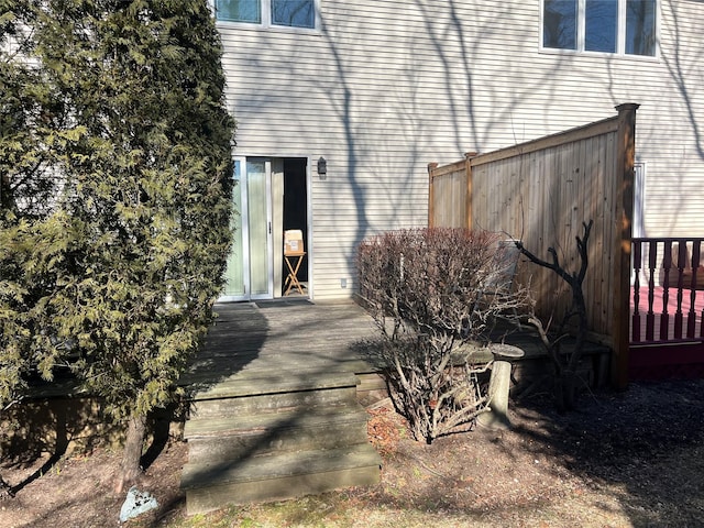 property entrance with a deck and fence