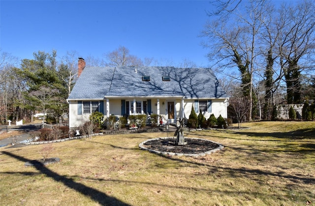 view of front facade featuring a porch, a front yard, and a chimney