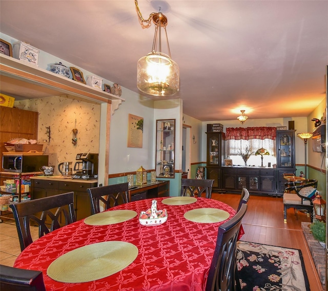 dining space with wood finished floors