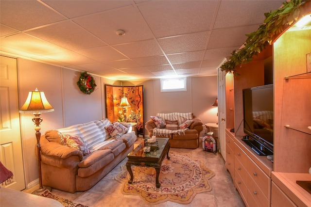 living room featuring a paneled ceiling