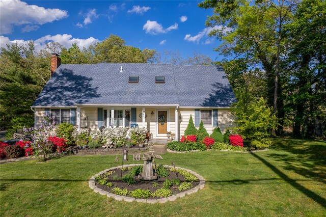 337 Mount Sinai Coram Rd, Mount Sinai, NY 11766 - cape cod-style house with roof with shingles, a front lawn, a chimney, and a porch