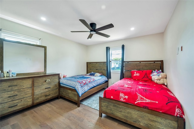 bedroom with a ceiling fan, recessed lighting, and wood finished floors