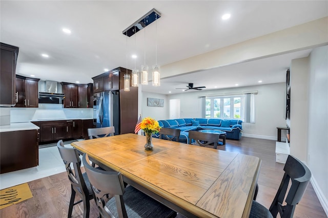 dining space with baseboards, ceiling fan, light wood finished floors, and recessed lighting