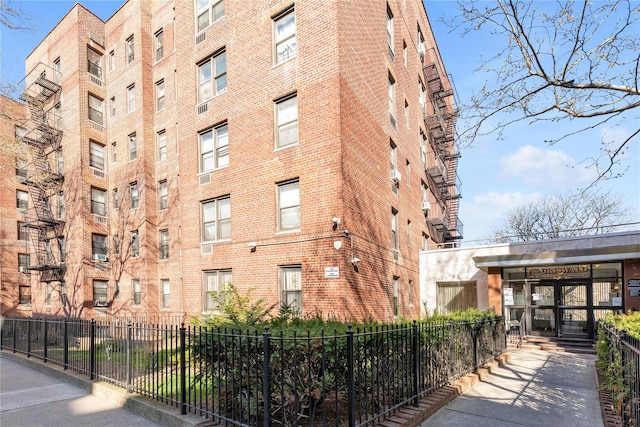 view of building exterior with fence