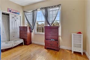 bedroom with baseboards and wood finished floors