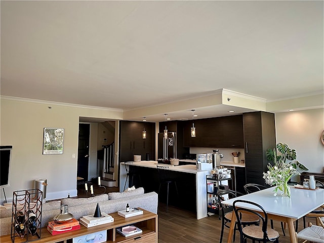 dining room featuring stairs, ornamental molding, and dark wood finished floors