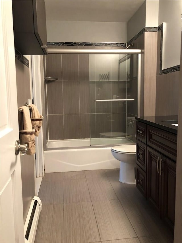 full bath with toilet, enclosed tub / shower combo, baseboard heating, and vanity