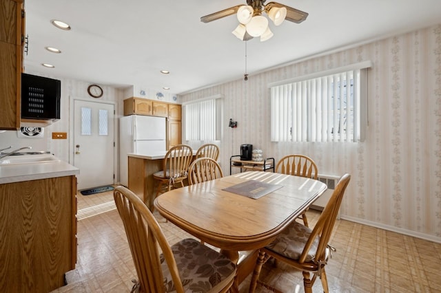 dining room with recessed lighting, baseboards, light floors, and wallpapered walls